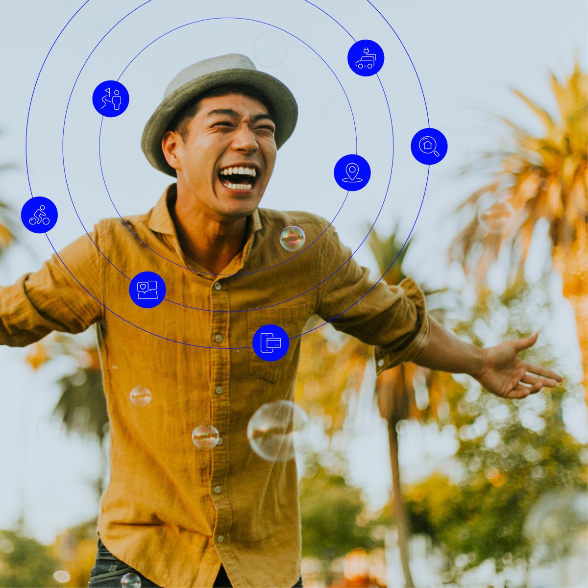 Young man outside on a sunny day surrounded by palm trees. Concentric blue rings surround him with images that describe his lifestyle.