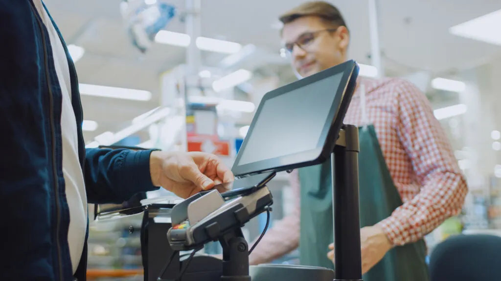 Shoppers in a grocery store aisle.