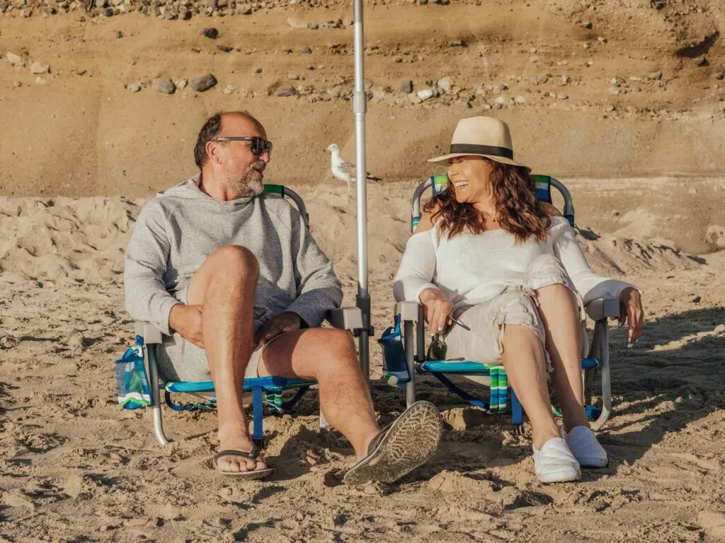 A Gen X couple on vacation on the beach.