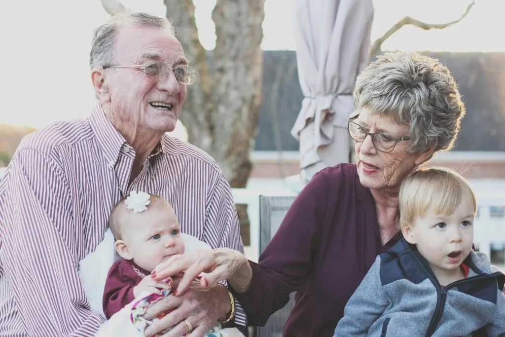 Two members of the Silent Generation with their grandchildren.