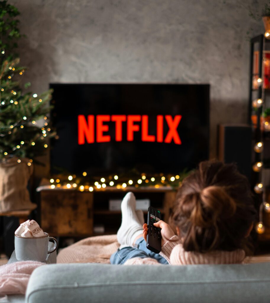 holiday marketing on CTV - a person watching Netflix surrounded by Christmas decorations