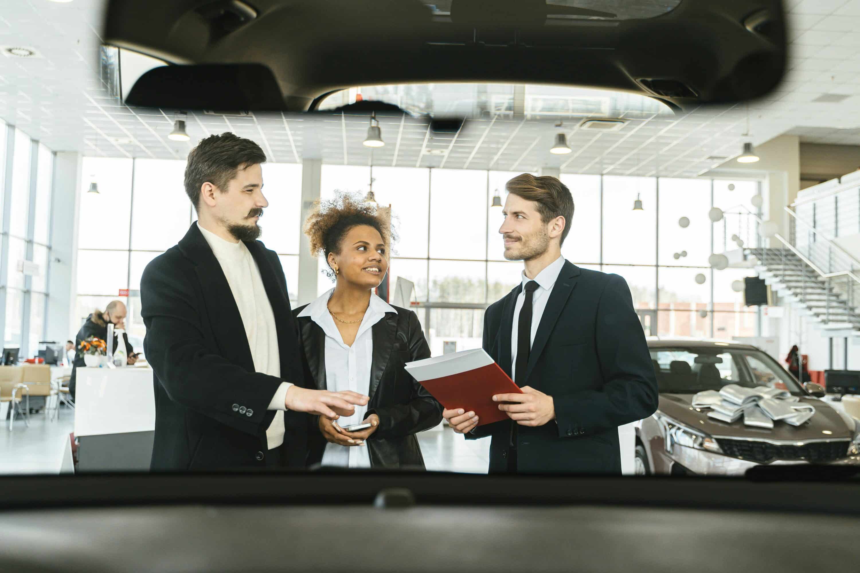 people in a car dealership, representing automotive marketing